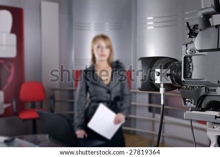 unrecognizable television news reporter in front of the video camera in studio
