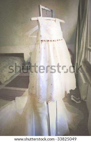 the dress of the flower girl before the wedding in a room