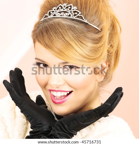 Prom Queen smiling excited looking at the camera with hands next to her pretty face