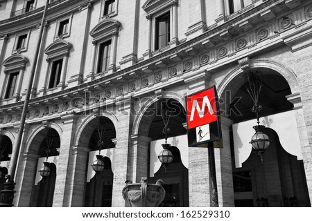 Subway sign against building in Rome Italy