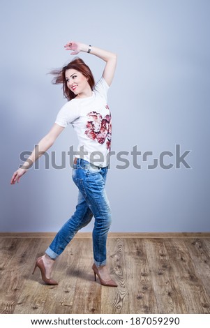 Happy young woman in motion looking back