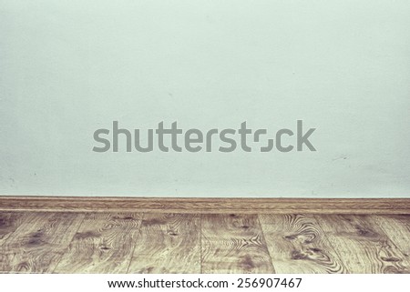 Indoor background with oak parquet and wall