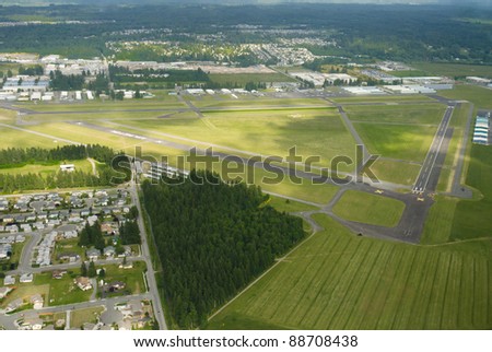 Lush green airport on partially cloudy day
