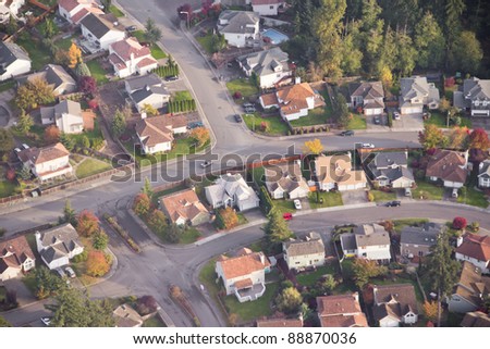 stock photo Aerial view of single car driving on a neighborhood road