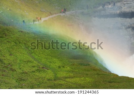 People walking behind the rainbow, Gullfoss (golden falls) waterfall, Golden circle, Iceland