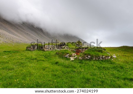 Remains of old viking farm covered with moss and grass, near Hofn, West Iceland