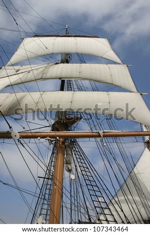 Wind fills the sails of a fully rigged clipper ship that once hauled tea from China but is now a museum