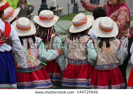 School girls in traditional native dress attend a festival in the plaza of Lima, Peru