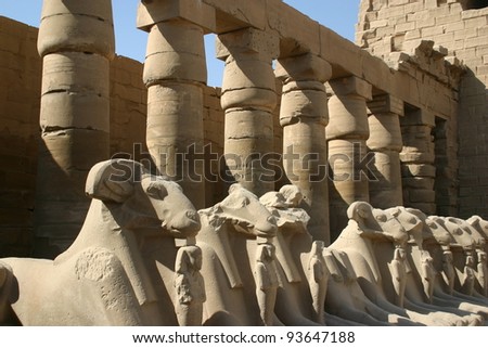 A row of stone carved dieties protects the temple entrance in Luxor, Egypt