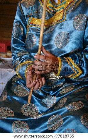 A close up of the hands of  Mongol Tuvan throat singer in remote northern China using a river reed to produce multiple sounds simultaneously