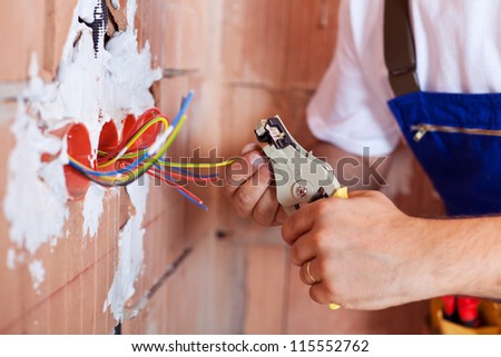 Electrician hands with pliers and a bunch of wires
