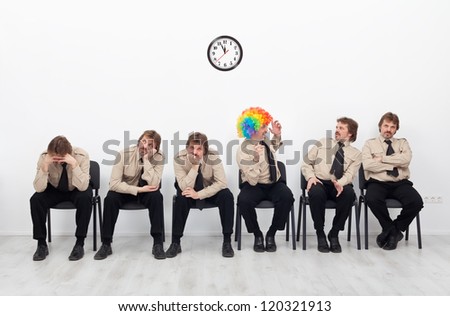 Stressed people waiting for a job interview - with a clown keeping up the good spirit