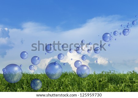 Spring fresh bubbles over green meadow against blue sky