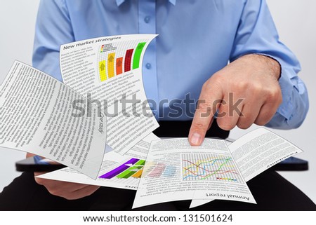 Businessman editing the annual report charts - working on a tablet computer