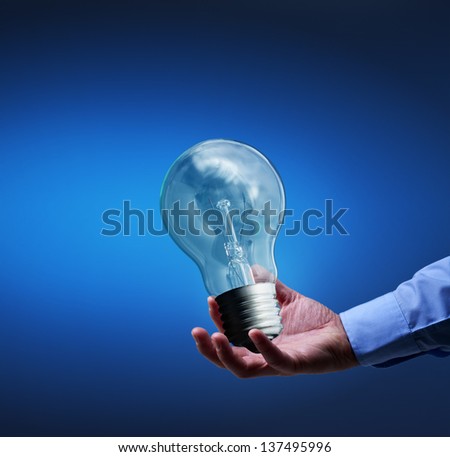 Presenting a new idea - businessman hand with old lightbulb