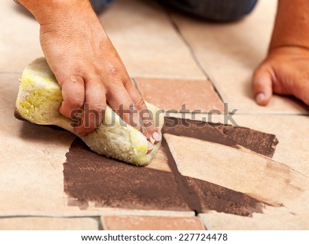 Installing ceramic floor tiling - testing the color of joint material, closeup