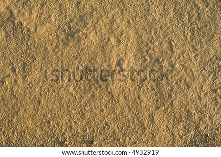 Fine grained dried mud background - in sunset lights
