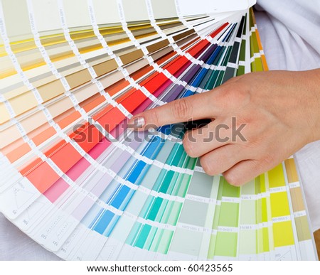 Woman hand pointing to a sample color chart