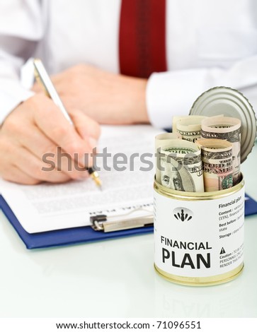 Business man making financial plan with an opened can of dollars - conceptual, closeup