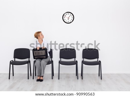 Still waiting for the job interview - woman checking time