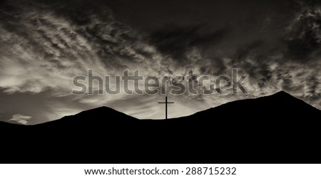 Beautiful Silhouette Image of a cross on top of a Mountain on the mexican Border