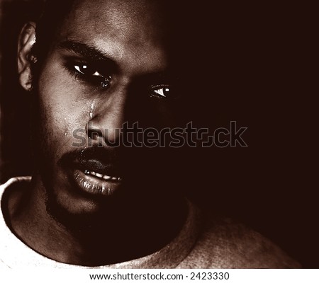 Portrait of a very sad black man crying
