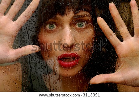 Beautiful brunette woman on the outside caught in the Rain