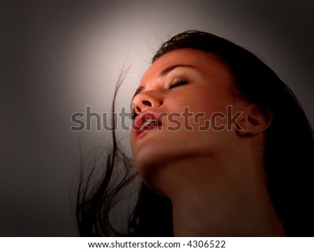 Alluring Portrait of a beautiful woman with dramatic Lighting