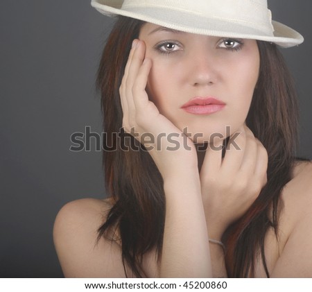Beautiful Image of a Fashion Model On Grey with Hat