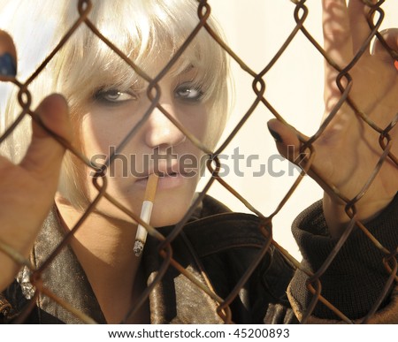 Outdoor Image of a tough Woman Smoking