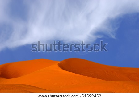 beautiful Image Of Red Sand Dunes with Blue sky and clouds