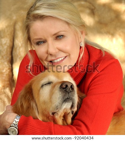 A beautiful Middle aged Woman who Loves her Golden Retriever