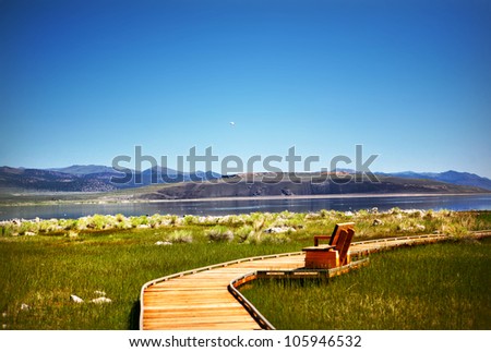 Wooden path winds through Mono Lake natural reserve on sunny summer day