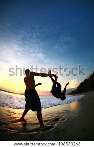 Two Men Jump In Pacific Ocean During Sunset