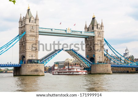 Tower Bridge raised to let ship pass through. London, England