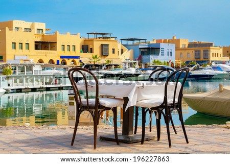 Table and chairs in sidewalk cafe at Abu Tig Marina. El Gouna, Red Sea, Egypt