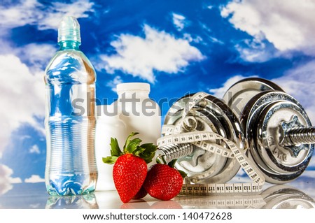 Fitness objects on the blue sky background