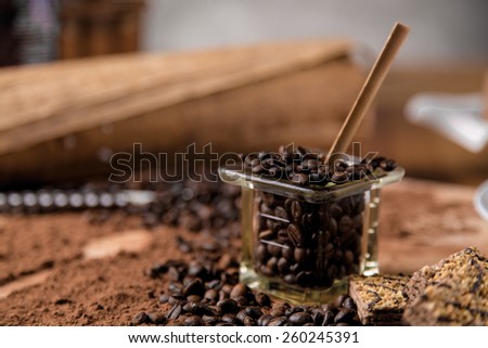 Dark concept with coffee on wooden table, organic