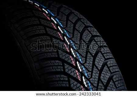 Car tires. Winter wheel profile structure on black background