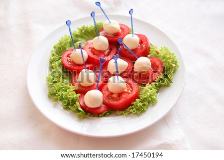 Red tomatoes with mayonnaise and salad leaves, soft focus