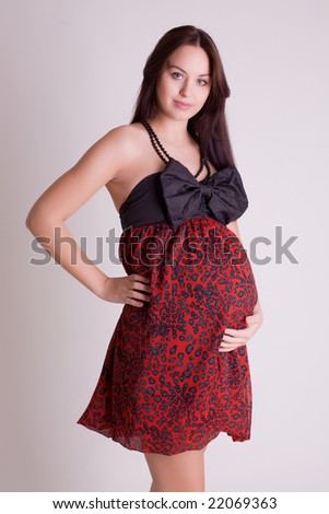 http://image.shutterstock.com/display_pic_with_logo/79219/79219,1229366825,1/stock-photo-beautiful-pregnant-women-in-red-dress-holding-her-belly-22069363.jpg