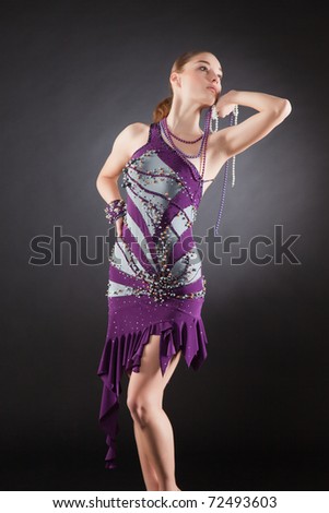 Looking up girl in violet dress holding pearls