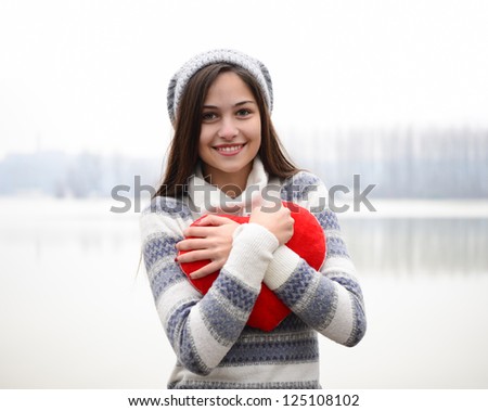 Young girl hugging heart