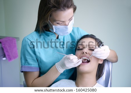beautiful young woman visiting dentist for dental checkup