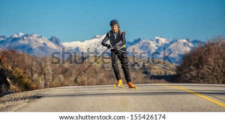 cross-country skiing with roller ski and mountain background