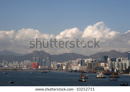 A view of Kowloon Bay: a mixture of commercial and residential buildings, and a background of mountains