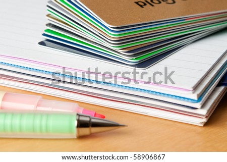 Close-up of a pile of credit cards on a notebook. Shallow depth of field, focus on the corners of the cards.