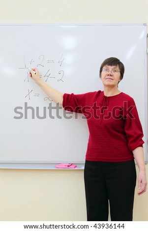 school teacher at the whiteboard