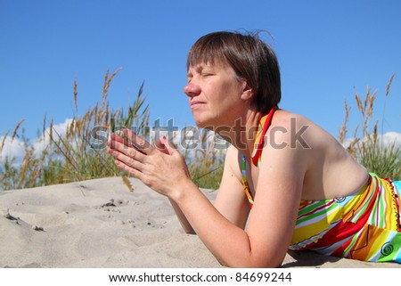 simple woman resting on the sand