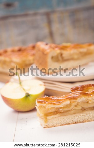 piece of fresh apple-pie with filling on a wooden background
